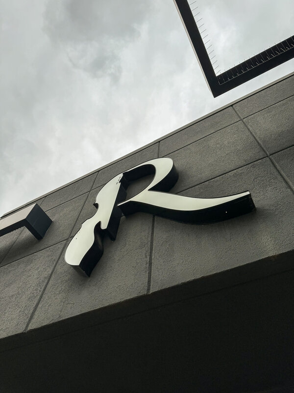 Resonate Music R logo on the school's exterior signage